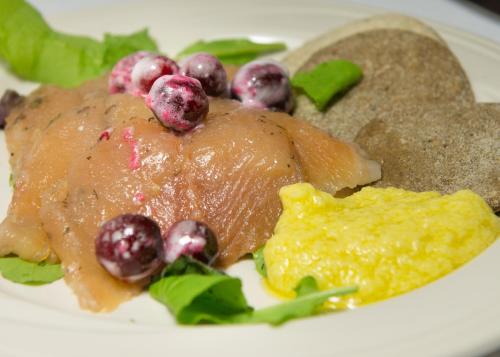 a plate of food with meat and fruit on it at Telegraph House Motel in Baddeck