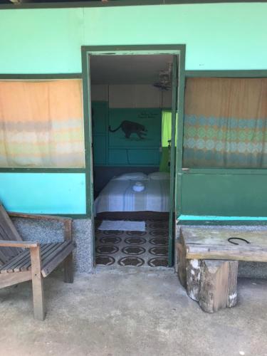 a doorway to a room with a dog on the wall at Life for Life Hostel Drake Bay Home of Sea Turtle Marine Conservation Project Osa Peninsula near San Josecito Beach in Drake