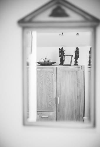 a mirror reflection of a kitchen with a cabinet at Schwaigeralm in Kreuth