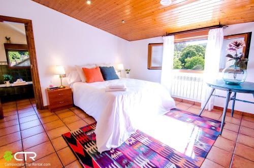 a bedroom with a white bed and a window at NATURAL ENVIRONMENT AND BEACHES-CTR in Valmaior