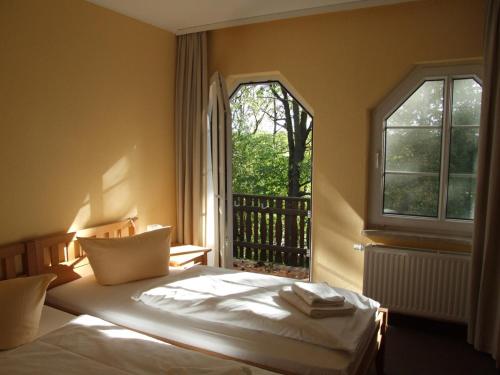 Krevet ili kreveti u jedinici u okviru objekta Parkstadthotel Bad Muskau
