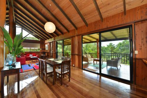 an open living room with a table and chairs at Tea Tree Cottage in Diwan