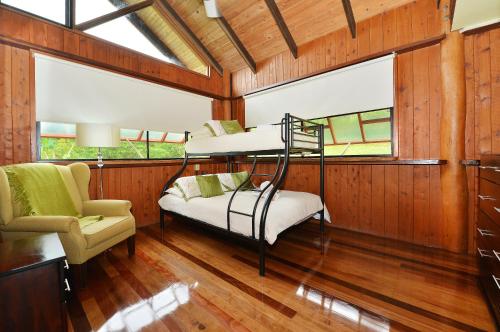 a room with two bunk beds and a chair at Tea Tree Cottage in Diwan