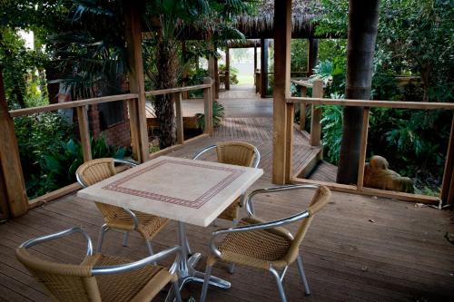 a table and chairs on a wooden deck at Sportsmans Motor Inn in Barooga