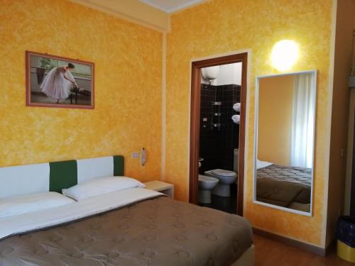 מיטה או מיטות בחדר ב-Albergo Roma