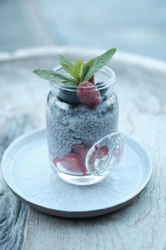 a jar with a plant in it on a plate at Eden Hotel, Apartments and Chalet Chamonix Les Praz in Chamonix-Mont-Blanc