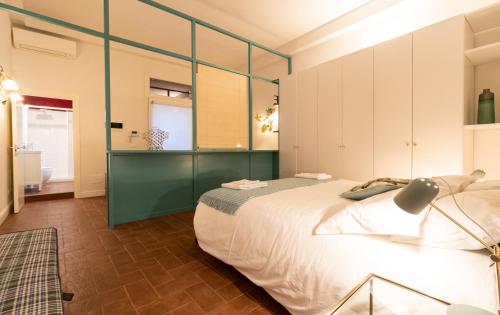 ボローニャにあるAsinelli Suite, privilegiata vista sulle due Torriのベッドルーム(白い大型ベッド1台、緑のキャビネット付)