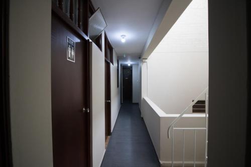 a hallway with a stairway leading down to a room at Kira's House in Piura