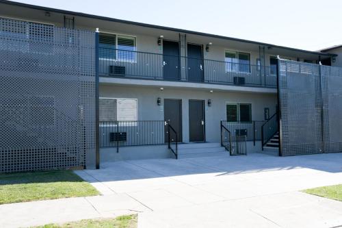 an apartment building with a gate and a balcony at Tilbury Inn in Glendale