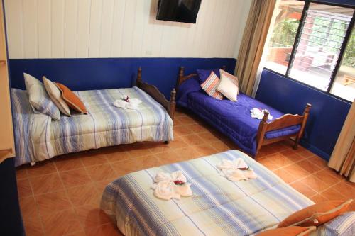 a living room with two beds and a couch at Horquetas River Lodge in Sarapiquí