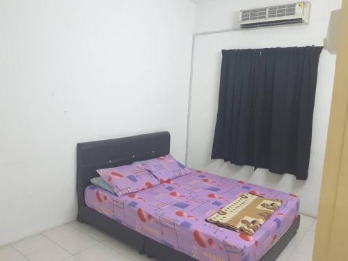 a small bedroom with a bed in a room at The Simple Homestay in Simpang Pulai