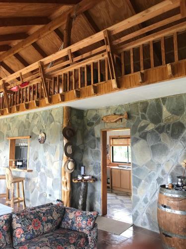 a living room with a couch and a barrel at Parcela de Agrado "Entre Lagos y Volcanes" in Puyehue