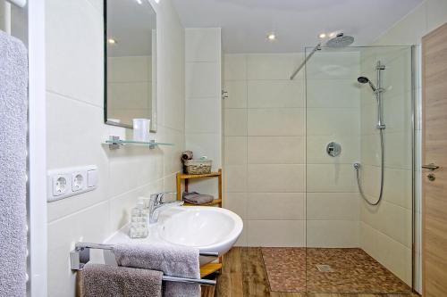 a bathroom with a sink and a shower at Landhaus Winkelmatten in Schönau am Königssee
