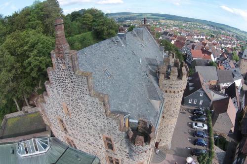 an aerial view of a large building in a town at Hotel Burg Staufenberg in Staufenberg