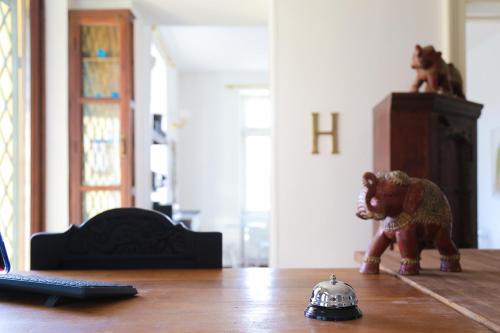 a toy elephant sitting on a table next to a laptop at Hotel Vila Katrca in Ljubljana