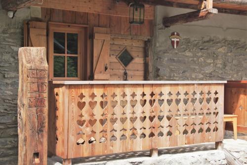 a wooden fence in front of a building at Ferme Saint-Aubin in Sainte-Foy-Tarentaise