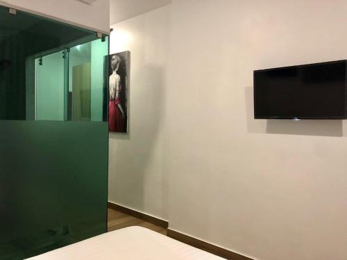 a room with a flat screen tv on a wall at Baan Saint-Tropez Seaview Villas Kata Beach in Kata Beach