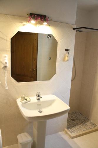 a bathroom with a sink and a mirror at Podere Fichereto Tuscany Apartment in Florence countryside in Scandicci