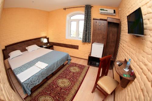 Ένα ή περισσότερα κρεβάτια σε δωμάτιο στο Star Hotel