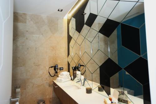 a bathroom with a sink and a mirror at Valentino Rooms in Focşani