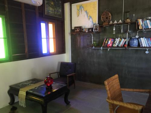 a room with a table and a chair and a window at Lanta Harbour in Ko Lanta