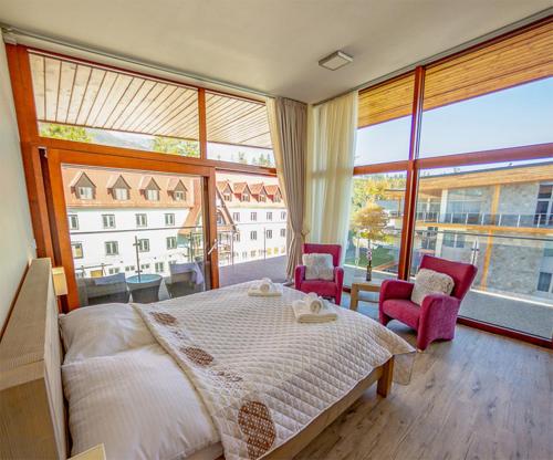 A bed or beds in a room at Apartmány Tatry