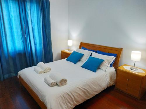 a bedroom with a large bed with towels on it at Oceanfront Apartment in Funchal