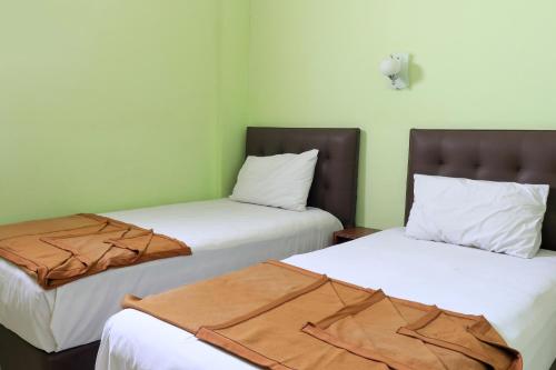 En eller flere senge i et værelse på Hotel Prisma