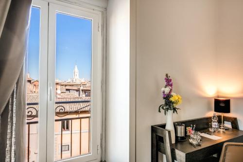 a room with a desk and a window with a view at Piccola Navona Roof Garden in Rome