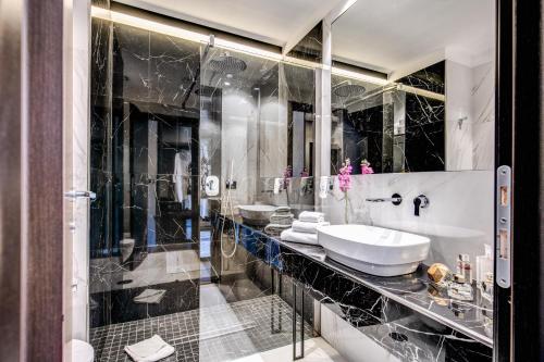 a bathroom with two sinks and a mirror at Piccola Navona Roof Garden in Rome