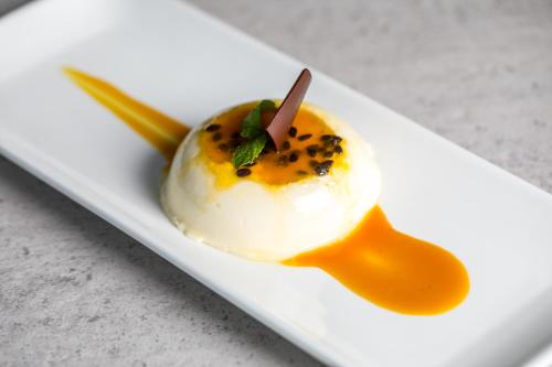 a dessert on a white plate on a table at Trillium Boutique City Hotel in Colombo