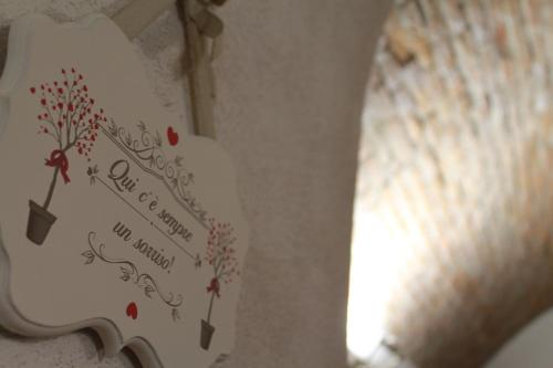 a sign on a wall with a tree on it at Hotel Europa Varese in Varese