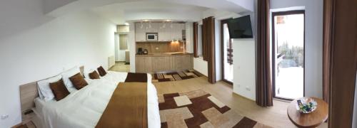 a living room with a couch and a table at Nature House Predeal in Predeal