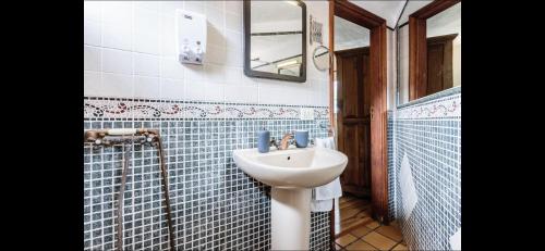 a bathroom with a sink and a mirror at Casa Cora Con Jacuzzi in Breña Baja
