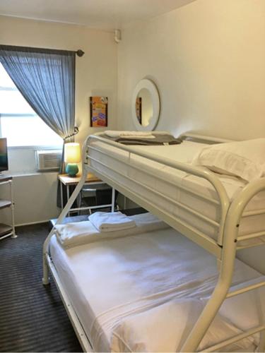 a bedroom with two bunk beds and a mirror at American Dream in New York