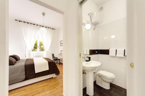 a bedroom with a bed and a sink and a toilet at Vatican Suites Happy Holidays in Rome