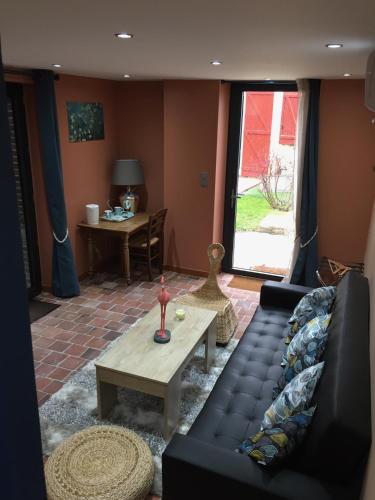 a living room with a couch and a coffee table at Le Rouge & Blanc in Mormont