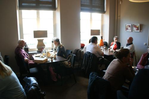 ルールモントにあるDe Pastorie Bed & Breakfastのレストランのテーブルに座っている人々のグループ