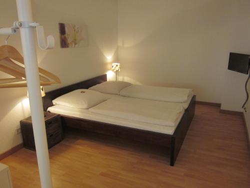a bed in a small room with at Hotel Waldesruh in Düsseldorf