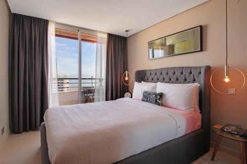 a bedroom with a large bed and a balcony at La Nogalera Deluxe Apartment Torremolinos in Torremolinos