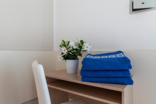 a table with towels and a potted plant on it at Hotel Sanremo in Milano Marittima