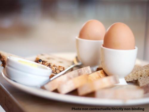 a plate of eggs and bread on a table at Ibis Jeddah Malik Road in Jeddah