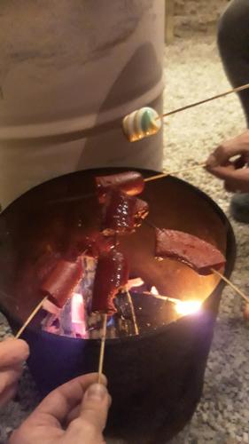 a person is cooking food in a pan at Kuyu Beergarden Hostel in Antalya