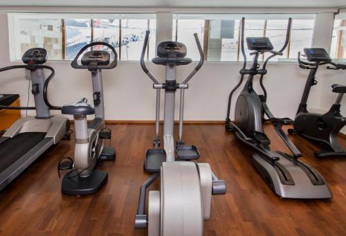 a group of treadmills and exercise bikes in a gym at Hotel Edelweiss Hochsölden Superior in Sölden