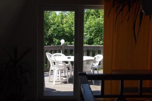 a patio with a table and chairs on a deck at Männi Guesthouse in Haapsalu
