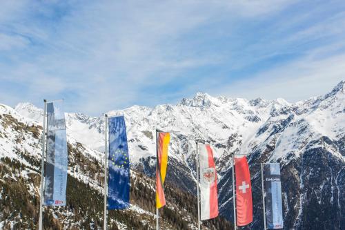 a group of flags on the side of a mountain at Hotel Edelweiss Hochsölden Superior in Sölden