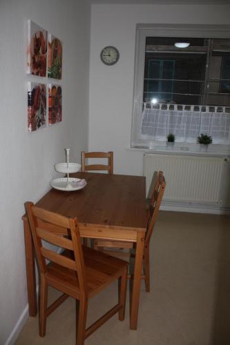 a wooden table and chairs in a room with a window at Andrea in Lübeck