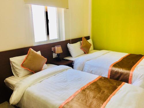 Postel nebo postele na pokoji v ubytování Hưng Long Hostel