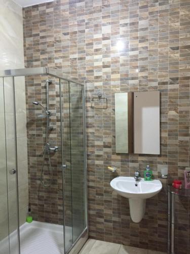 a bathroom with a sink and a shower at Seafront Room in Msida