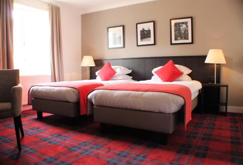 Säng eller sängar i ett rum på Hotel Golf de Pierpont
